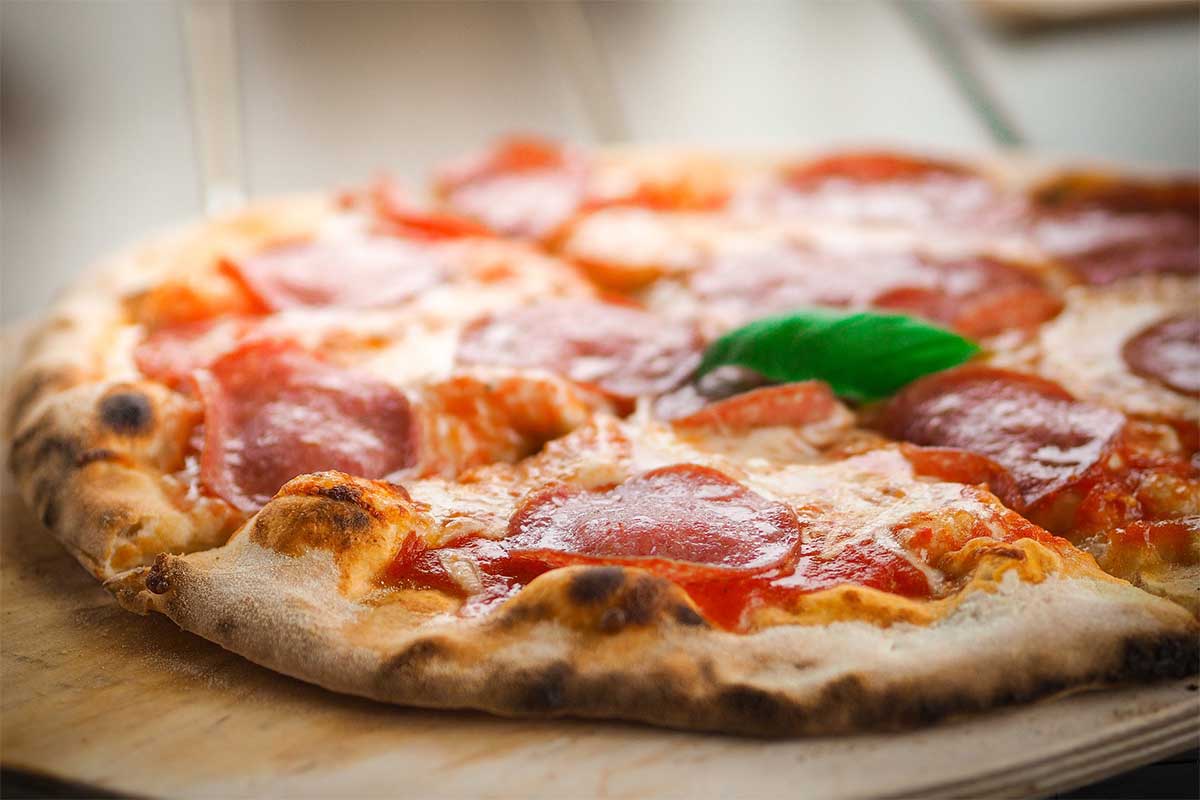 Taking Slice of Homemade Pizza